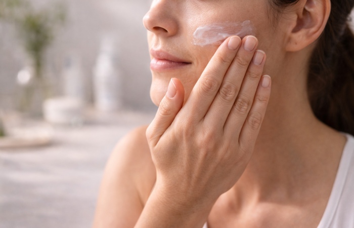 Applying lightweight moisturizer during daily skincare routine