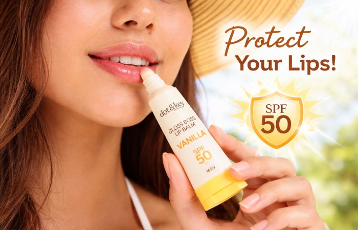 Person applying lip balm outdoors under sunlight